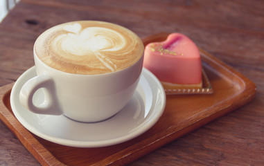 Close up cup of Coffee, latte on the wooden table - Vintage Filter Effect