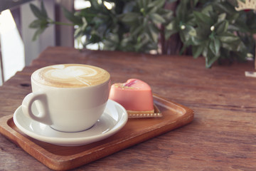 Close up cup of Coffee, latte on the wooden table - Vintage Filter Effect