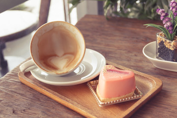 Close up cup of Coffee, latte on the wooden table - Vintage Filter Effect
