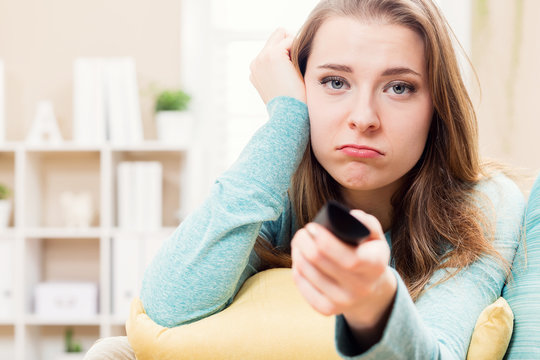 Bored Young Woman Watching TV