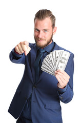 Attractive businessman wearing a blue suit and tie, holding a big fan of 100 dollar bills, with a big smile on his face. White background.
