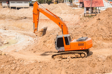 Orange excavator on a working platform