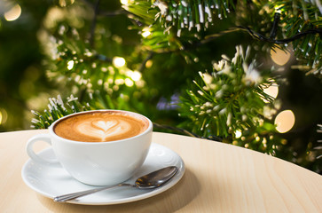 Photo of beautiful Christmas light festive, white coffee cup on