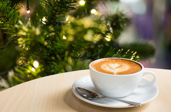 Photo of beautiful Christmas light festive, white coffee cup on