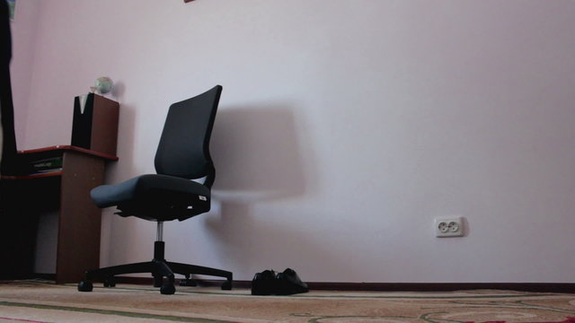 A man takes his jacket off the chair.NTSC