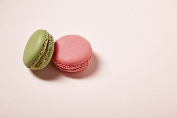 pink and green macaroons on pink background