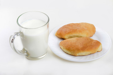 glass of milk and cakes on a plate