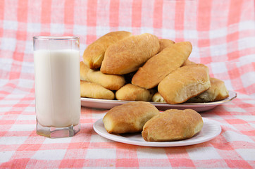 glass of milk and cakes on a plate