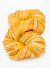 Fresh and tasty croissant on white background