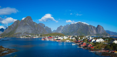 Beautiful super wide-angle summer aerial view of Reine, Norway, Lofoten Islands, with skyline, mountains, famous fishing village with red fishing cabins, Moskenesoya, Nordland - obrazy, fototapety, plakaty