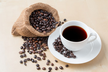 Cup of coffee and fresh roasted organic Coffee beans on isolated background, food and drink background