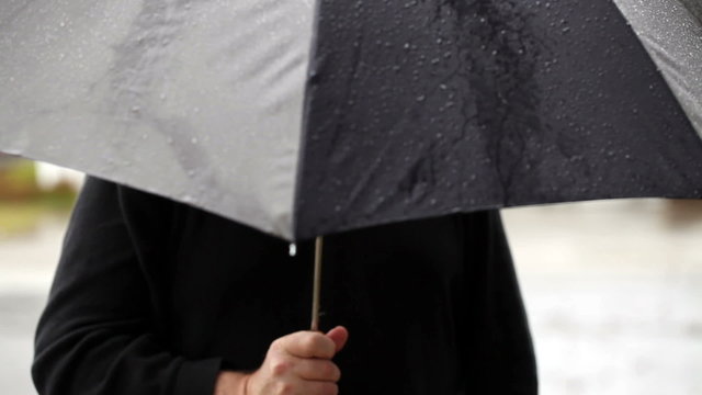 Man Holding Grey And Black Umbrella In The Rain
