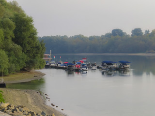Fototapeta na wymiar Boats on the Danube River at the foggy morning, Szentendre, Hungary