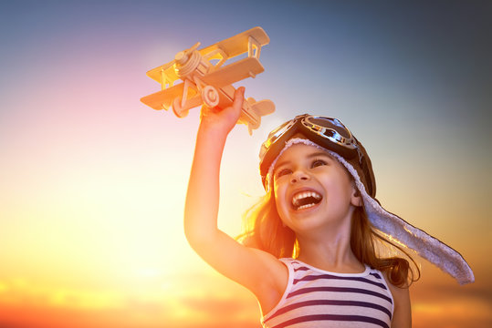 girl playing with toy airplane