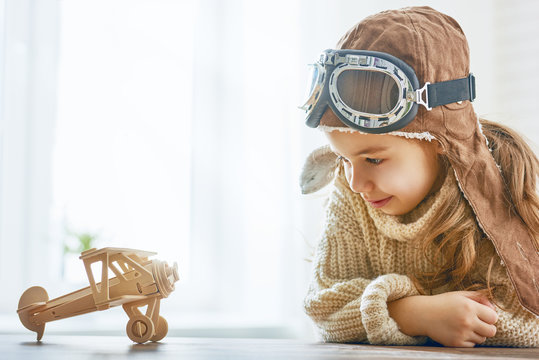 Girl Playing With Toy Airplane