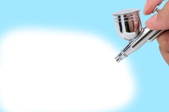 Air Brush Spray Gun In Hand  Isolated White Background With Clipping Path