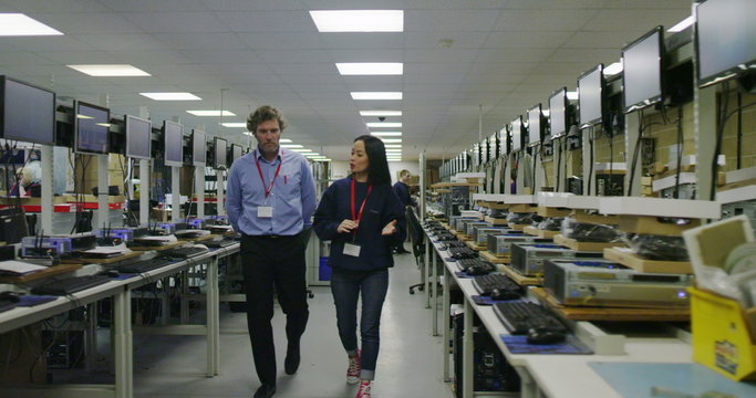 Team of workers in electronics factory working on computer testing and repairs