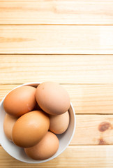 hen eggs on wood background