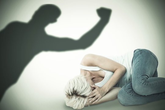Composite image of sad blonde woman lying on the floor 