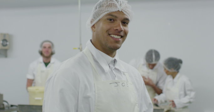 Portrait of cheerful worker in a seafood processing factory