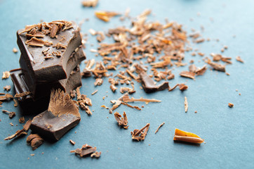 Broken chocolate bar, chips and powder. Shallow depth of field.