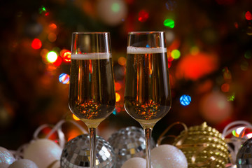 Two champagne glasses and christmas balls
