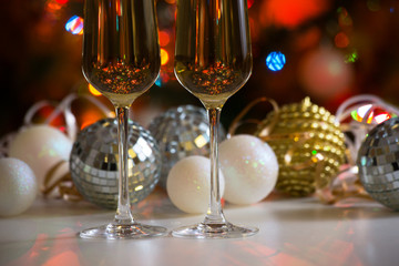 Two champagne glasses and christmas balls