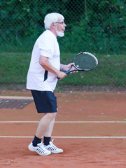 Senior man playing tennis