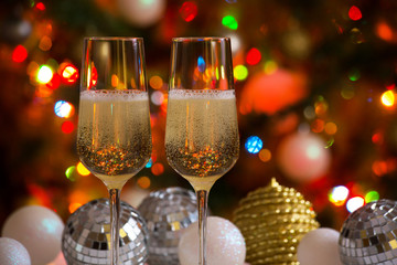 Two champagne glasses and christmas balls