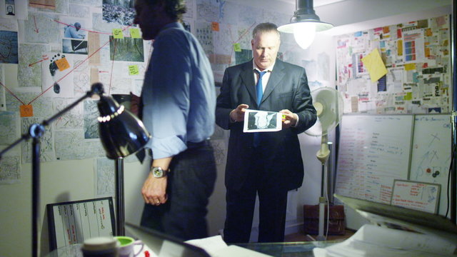  Police detectives working together in incident room to try and solve a case