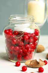 viburnum jar with candle on wooden table