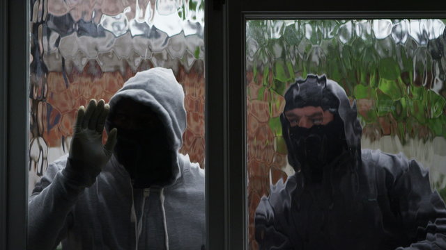  2 masked burglars breaking and entering into a victim's home