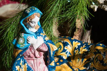 Painted pottery statue portraying the virgin Mary in the ceramic nativity scene of an artisan in Caltagirone
