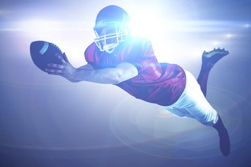 Composite image of american football player scoring a touchdown