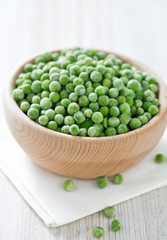 frozem peas on wooden surface