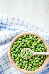 frozem peas on wooden surface