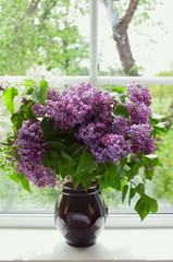 bunch of lilac in vase on window-sill