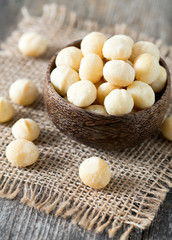 salted macadamia nuts on wooden surface