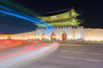 Traffic blurs past Gyeongbokgung palace at night in Seoul, South