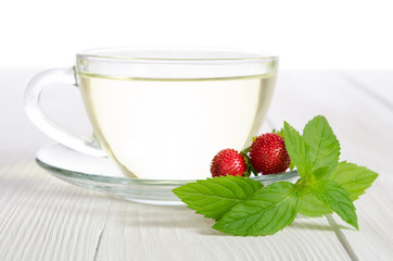 Cup of tea and strawbarries on the white wooden table