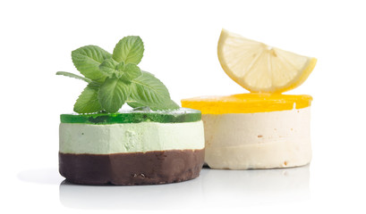 two cakes with lemon and mint on white background