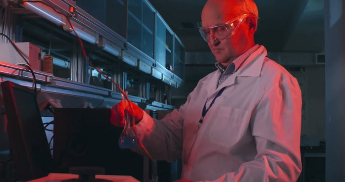 Professor conducting chemistry experiment in his lab 