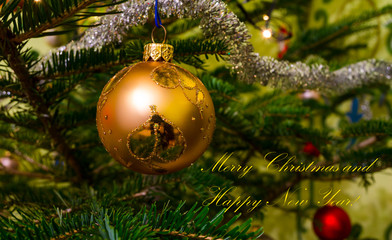 Merry Christmas greeting card with Christmas balls hanging on ch
