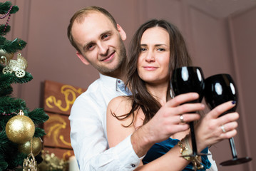 Merry Christmas and Happy New Year. Young beautiful couple in lo