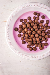 Obraz na płótnie Canvas Fruit yogurt with chocolate topping in the ceramic dish vertical