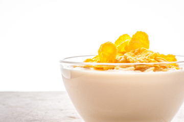 Natural yogurt in glass bowl with cornflakes horizontal