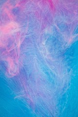 Blue pink clouds of ink in liquid