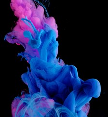 Blue pink clouds of ink in liquid isolated on black