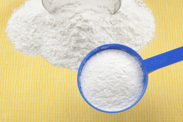 Whey protein in measure scoop.Selective focus