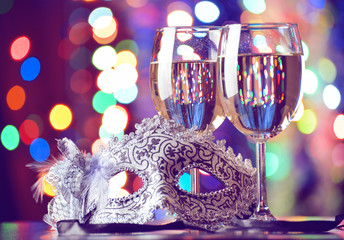 new year mask and glasses of champagne